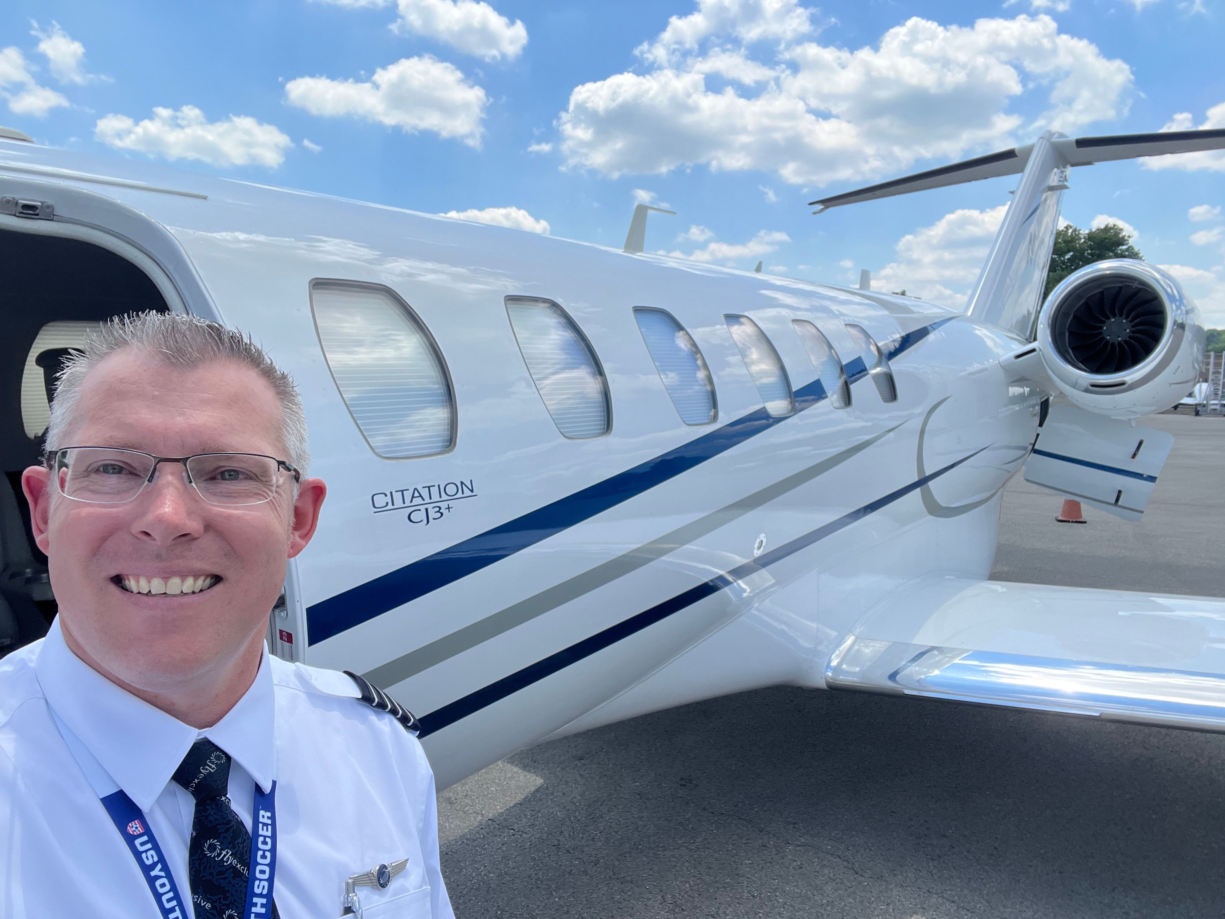 Travis Alkire in uniform next to a Citation CJ3+